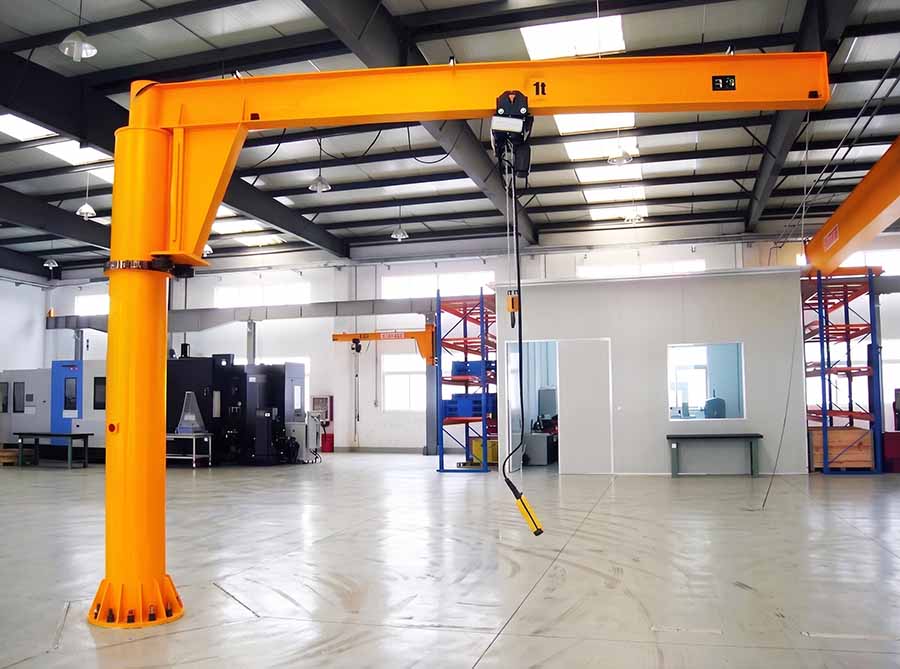 Foundationless jib crane lifting components at an assembly workstation Foundationless jib crane lifting components at an assembly workstation